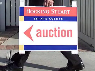 Maurice DiMarzio, senior auctioneer at melbourne real estate agent Hocking Stuart, outside house in East Hawthorn 08 May 2002. auction sign