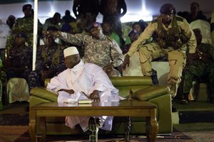 Gambian officers signal to the media not to block the public's view during President Yahya Jammeh's final rally in Banjul, Gambia, Tuesday Nov. 29, 2016. Gambia's opposition parties are rallying together behind a single candidate for the first time in decades, forming a coalition they hope will oust longtime President Yahya Jammeh, who has been accused of human rights abuses throughout his 22-year rule.