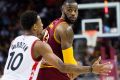  LeBron James looks for a pass while under pressure from Toronto's DeMar DeRozan.