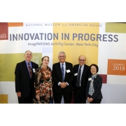 Group shot in front of Innovation in Progress banner