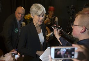 In this Oct. 6, 2016, photo, Green party presidential candidate Jill Stein, center, takes questions from reporters during a campaign stop at Humanist Hall in Oakland, Calif.