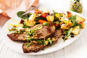 Beef steaks with warm almond and parsley salsa