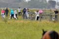 Potential illegal labourers try to escape a police and immigration raid on the Vizzarri asparagus farm at Koo Wee Rup, ...