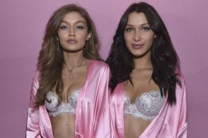 Sisters Gigi and Bella Hadid pose backstage prior to the 2016 Victoria's Secret Fashion Show in Paris.