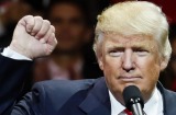 President-elect Donald Trump raises his fist as he speaks during the first stop of his post-election tour.