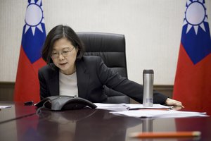 In this Friday, Dec. 2, 2016 photo released by Taiwan Presidential Office Saturday, Dec. 3, 2016, Taiwan's President Tsai Ing-wen speaks with U.S. President-elect Donald Trump through a speaker phone in Taipei, Taiwan.