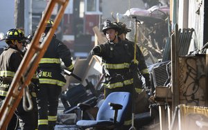 Firefighters assess the scene where a deadly fire tore through a late-night electronic music party in a warehouse in Oakland, Calif., Saturday, Dec. 3, 2016.