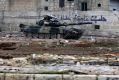 A Syrian army tank is seen in front of a wall bearing the legend "Aleppo is the capital of culture" in the east Aleppo ...