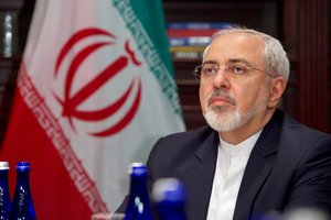 File - Iranian Foreign Minister Javad Zarif listens as U.S. Secretary of State John Kerry addresses reporters before a bilateral meeting on April 22, 2016, at the Lotte Palace Hotel in New York, N.Y.