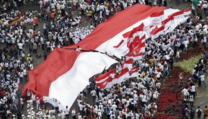 Indonesians display a large national Red-White flag during a rally in Jakarta, Indonesia,  Sunday, Dec. 4, 2016.