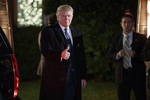 President-elect Donald Trump gestures toward reporters as he arrives for a party at the home of Robert Mercer, one of his biggest campaign donors, Saturday, Dec. 3, 2016, in Head of the Harbor, N.Y.