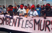 Migrants demonstrate, Calais: banner reads Tombent les murs [May the walls fall]