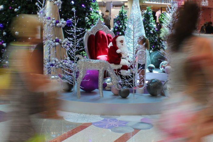 Shoppers walk past Santa in Grand Central Shopping Centre Toowoomba