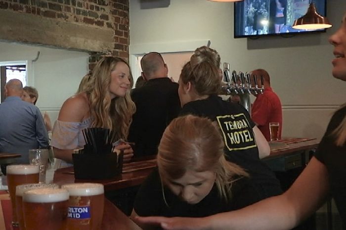 People being served at a bar