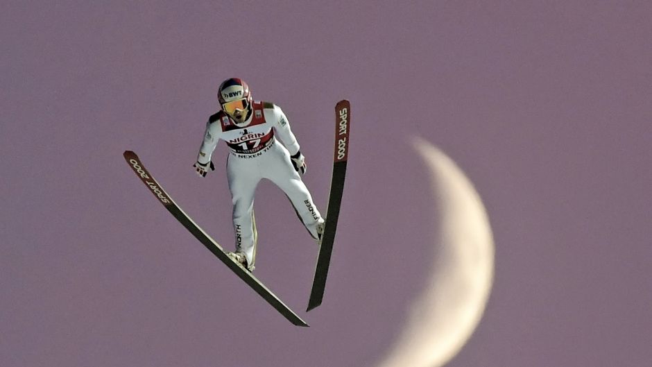 Jakub Janda of Czech Republic jumps in front of the rising moon.