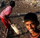 Slum children, some of whom played minor roles in the Golden Globe-winning film "Slumdog Millionaire", play cricket at ...