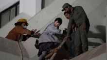 Pakistani volunteers help a foreigner to escape following a fire