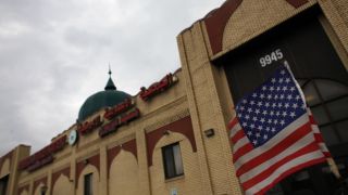 An American flag hangs on a car outside the American Muslim Society mosque in Detroit, Michigan April 5, 2011.