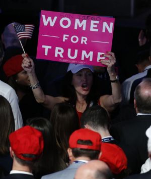 An attendee holds a "Women For Trump" sign during an election night party for U.S. President-elect Donald Trump at the ...