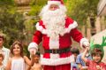 Santa and kids cool off in a City Square moat on Sunday.