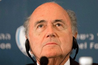 A headshot of Sepp Blatter listening at a press conference.