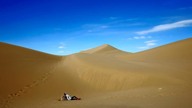 An Iranian woman relaxes on the sands while enjoying her weekend in the Mesr desert about 305 miles (500 kilometers) ...