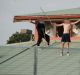 Youths protesting on the roof of the Melbourne Youth Justice Centre at Parkville in March.