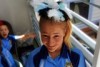 A high school student shows off the fascinator on her head.