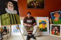 Patrick Francis, an award-winning artist, sportsman and autism ambassador, surrounded by his paintings at his family's ...