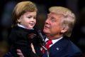 Donald Trump holds two-year-old Hunter Tirpak, who is dressed as Trump, during a rally in Pennsylvania last week.