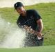 NASSAU, BAHAMAS - DECEMBER 01: Tiger Woods of the United States hits a shot from a greenside bunker on the 14th hole ...