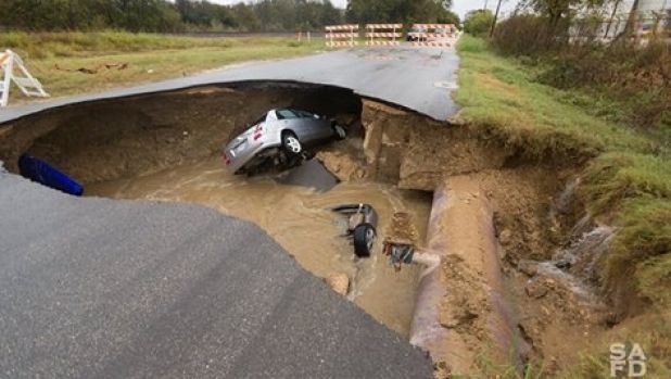 The sinkhole swallowed two cars.