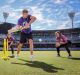 Nick Riewoldt has a hit as Gemma Triscari, Emma Inglis, Jess Cameron and Alana King field at the MCG on Friday.