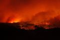 Flames sweep towards the heritage-listed NSW Central Coast town of Catherine Hill Bay on October 12, 2013.