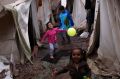 Children play among tents at Ritsona refugee camp north of Athens, which hosts about 600 refugees and migrants.