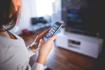 A woman using an iPhone.