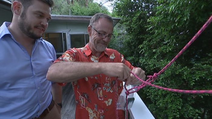 Reporter Andy Park watches as David Sneddon explains how he gets an internet connection when the NBN drops out.