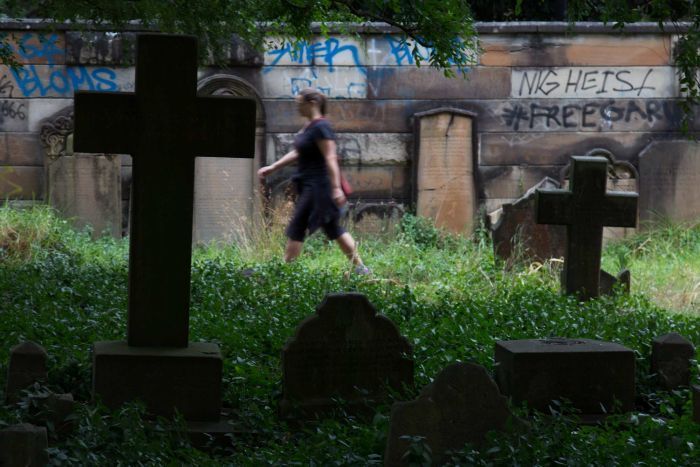 Woman walks through Camperdown Cemetery, Newtown