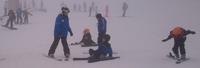 These kids are sitting and playing in sewer water snow with no eye protection