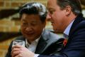 Then British PM David Cameron, right, drinks a pint with Chinese President Xi Jinping, at The Plough pub in Casden.