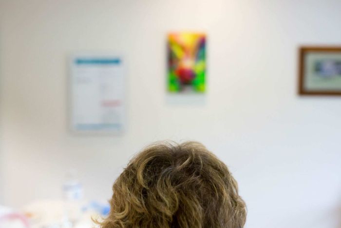 Sue Jensen awaits a doctor.