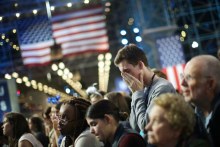 A devastated Clinton supporter buries his head in his hands