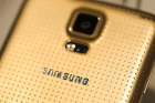 The reverse side of a gold colored Galaxy S5 smartphone is seen during a Samsung Electronics Co. news conference ahead ...