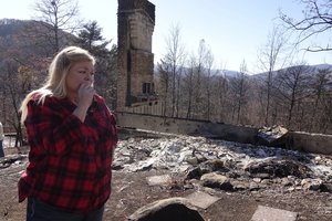 Tammy Sherrod views the remains of her home in the Roaring Fork neighborhood of Gatlinburg, Tenn., Friday, Dec. 2, 2016.