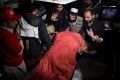 Pakistani volunteers move remains of plane crash victims to a mortuary at a hospital, in Abbottabad.