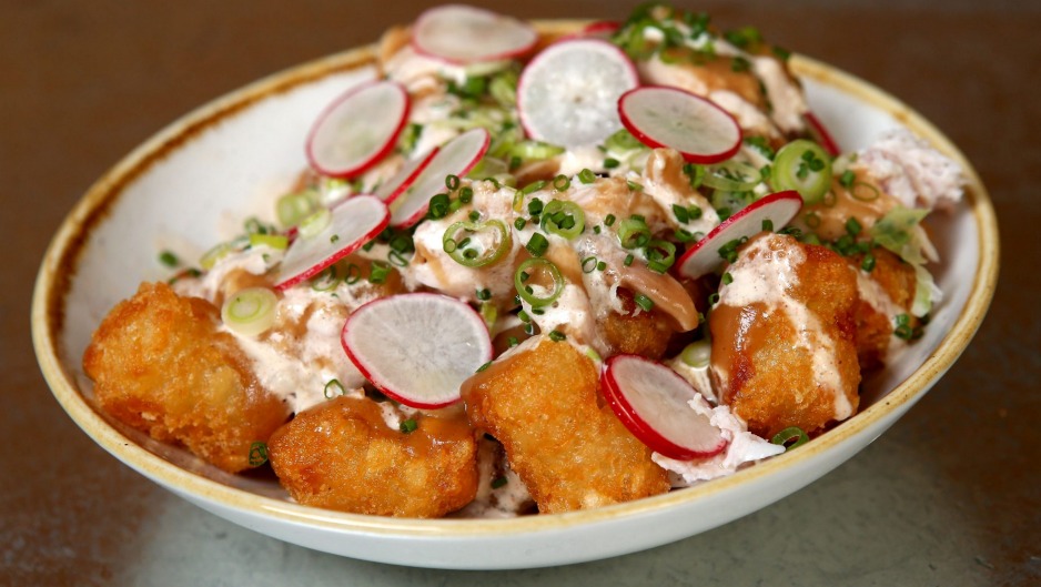 Tater tots topped with blue cheese dressing, radish and smoked chicken.