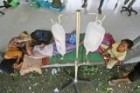 Earthquake survivors receive medical treatment outside of a hospital in Meureudu, Aceh.