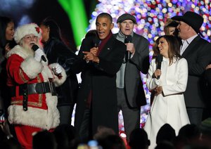 President Barack Obama, sings "Jingle Bells," with Santa Claus, James Taylor, Eva Longoria, and Garth Brooks during the lighting ceremony for the 2016 National Christmas Tree is seen before the lighting ceremony on the Ellipse near the White House, Thursday, Dec. 1, 2016 in Washington.