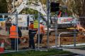 Fencing is erected on Northbourne Avenue as Capital Metro undergoes earthworks for the light rail project.