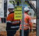 Fencing is erected on Northbourne Avenue as Capital Metro undergoes earthworks for the light rail project.